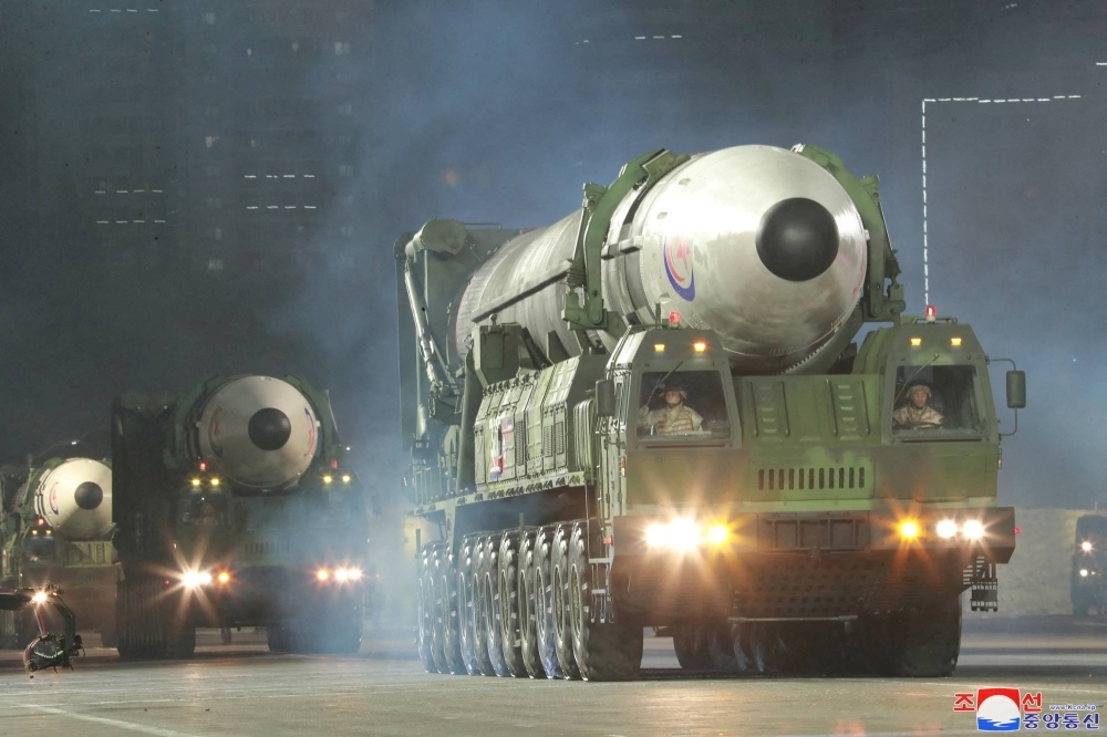 Hwasong-17 intercontinental ballistic missiles take part in a nighttime military parade to mark the 90th anniversary of the founding of the Korean People's Revolutionary Army in Pyongyang in this undated photo released in April 2022.
