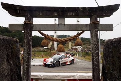 Elfyn Evans and his co-driver Scott Martin drive their Toyota GR Yaris Rally1 Hybrid past the Kumano Shrine during Rally Japan in Toyota, Aichi Prefecture, on Saturday. 