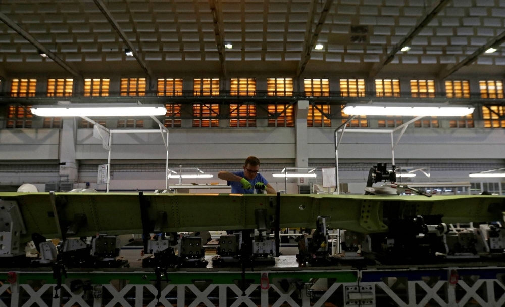 An employee works on the assembly line in a hangar of an aircraft manufacturer near the town of Odolena Voda, Czech Republic, in July 2017.