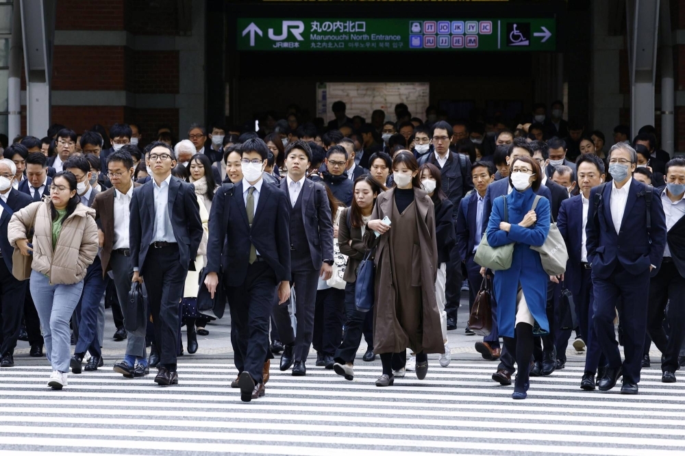 Commuters at Tokyo Station earlier this month. A Reuters poll showed six out of 10 economists expect major firms' pay hikes in 2024 to exceed this year's.