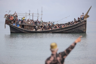 Newly arrived Rohingya refugees are stranded on a boat after the nearby community decided not to allow them to land in Aceh province, Indonesia, on Nov. 16.