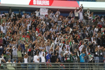 Palestinian fans cheer during their team's World Cup qualifying match against Australia in Kuwait City on Tuesday. 