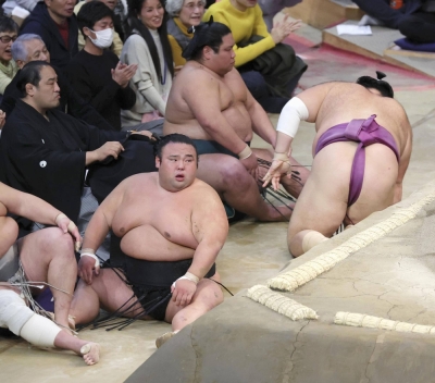 Takakeisho (seated, left) following his loss to Asanoyama on Sunday in Fukuoka. 