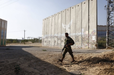 An Israeli soldier patrols near the border fence that separates the Gaza Strip and the Jewish state on Friday.