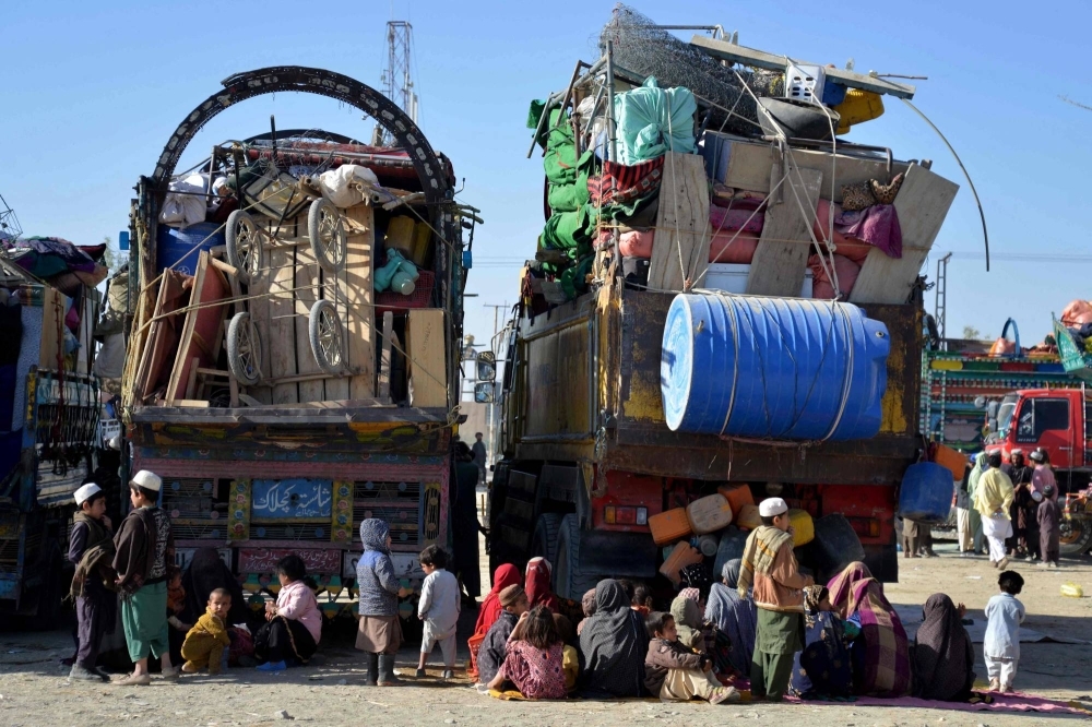 Afghan refugees sit with their belongings near the Afghanistan-Pakistan border on Nov. 20. 