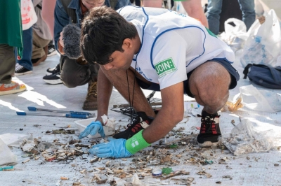 A member of the India team sorts through rubbish at the end of the first round of the Spogomi World Cup 2023 final, in which teams pick up as much rubbish as possible in a set amount of time, in Tokyo's Shibuya Ward on Wednesday. 
