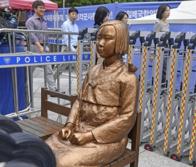 A statue symbolizing "comfort women" — those who suffered under Japan’s military brothel system before and during World War II — in front of the Japanese Embassy in Seoul