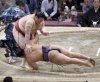 Atamifuji (left) defeats Hoshoryu on Day 12 of the Kyushu Grand Sumo Tournament at Fukuoka Kokusai Center on Thursday. | KYODO