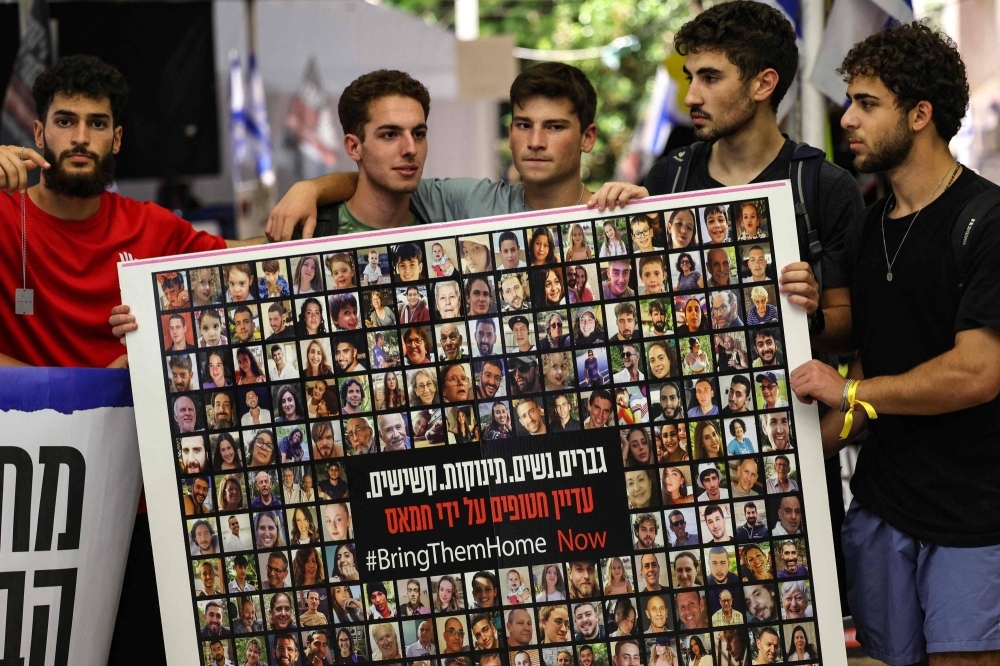 Relatives, friends and supporters of Israeli hostages held in Gaza since the Oct. 7 attack by Hamas militants in southern Israel hold placards and images of those taken, during a protest for their release in Tel Aviv on Wednesday.
