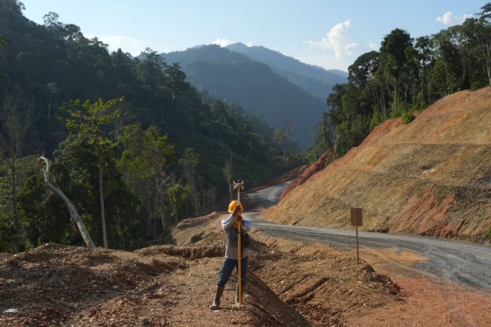 A surveyor at work at the Mentarang Induk Hydropower Plant construction site in North Kalimantan in October. 