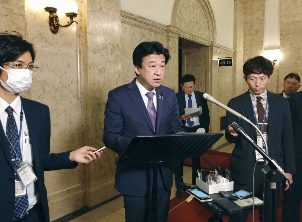 Defense Minister Minoru Kihara speaks to reporters in Tokyo on Friday.