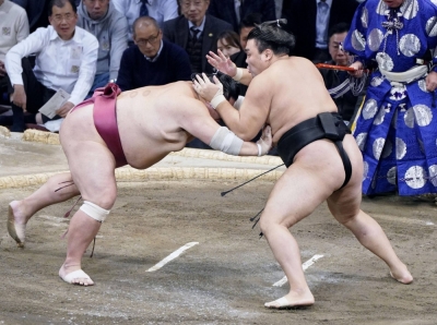 Kirishima (right) battles Daieisho during the Kyushu Grand Sumo Tournament in Fukuoka on Friday.