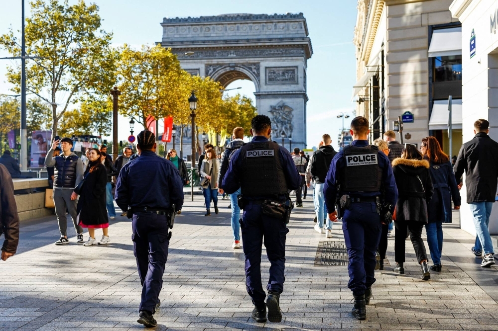 Police patrol the Champs Elysees in Paris last month amid security concerns following a deadly knife attack in northern France. 