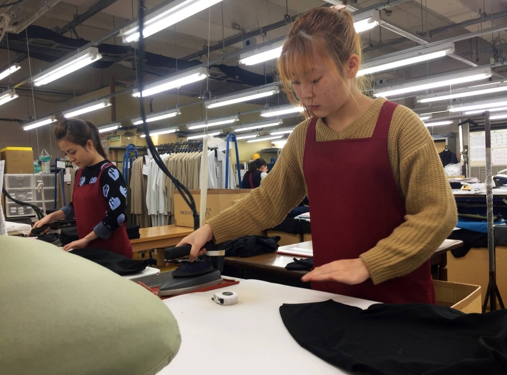 Technical trainees from Vietnam work at a knitwear factory in Mitsuke, Niigata Prefecture. 