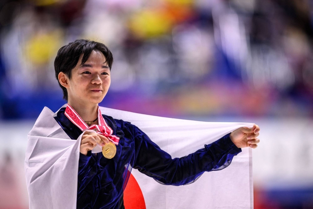 Gold medalist Yuma Kagiyama celebrates after winning the NHK Trophy competition.