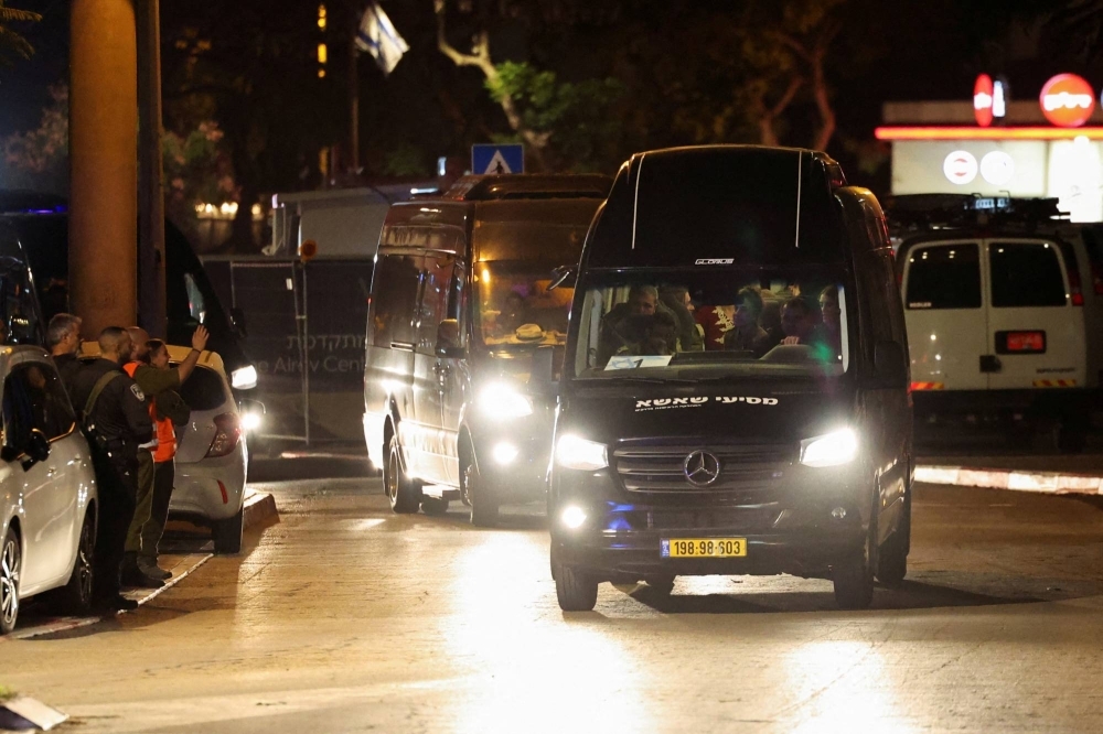 A vehicle carrying hostages released as part of a deal between Israel and the Hamas militant group arrives at a medical center in Ramat Gan, Israel, on Sunday. 