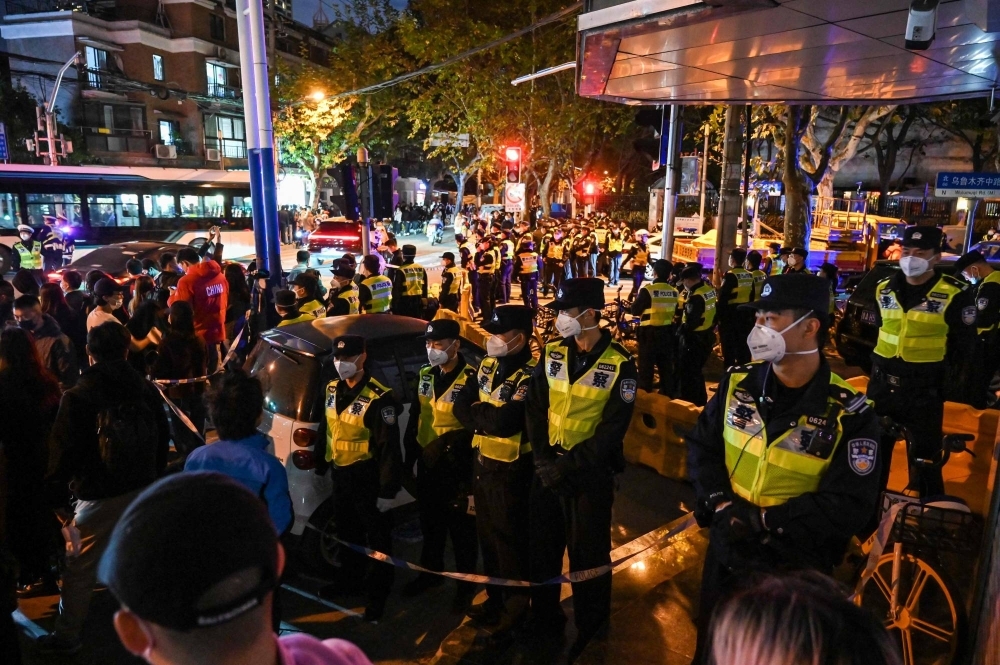 Police officers block Wulumuqi Street in Shanghai on Nov. 27, 2022, amid protests over China's 'zero-COVID' policy.