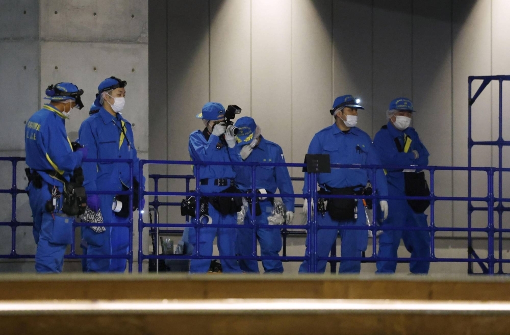 Kanagawa Prefectural Police officers examine an area outside the K-Arena Yokohama facility in Yokohama on Thursday.