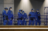 Kanagawa Prefectural Police officers examine an area outside the K-Arena Yokohama facility in Yokohama on Thursday. | Kyodo