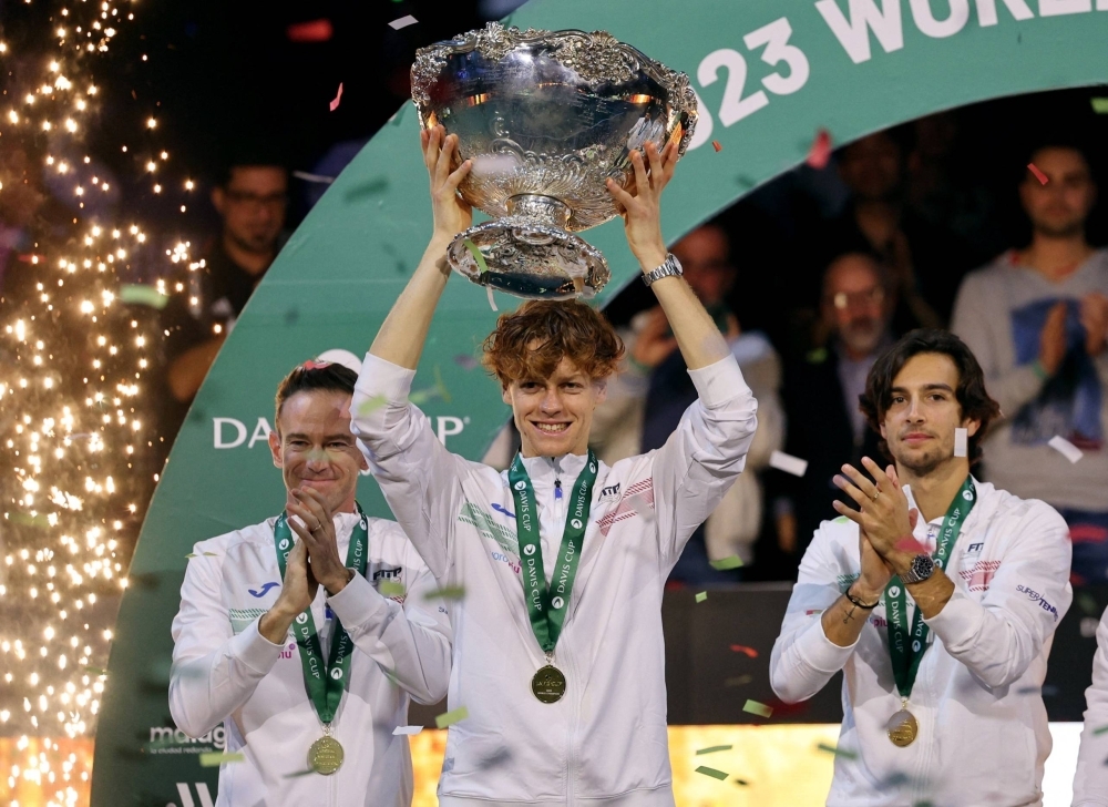 Jannik Sinner lifts the trophy after helping Italy defeat Australia in the Davis Cup final in Malaga, Spain, on Sunday.