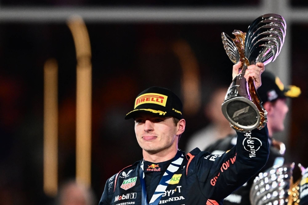 Max Verstappen celebrates on the podium after winning the Abu Dhabi Grand Prix on Sunday.