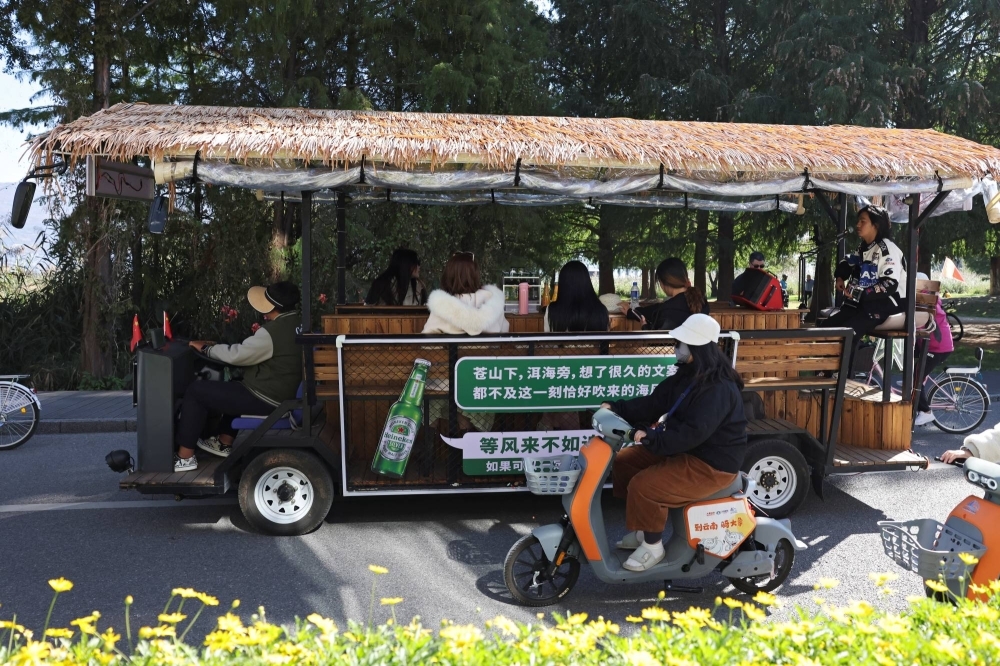 A man sings for customers touring the Erhai lake on a sightseeing bus in Dali, in China's Yunnan province.