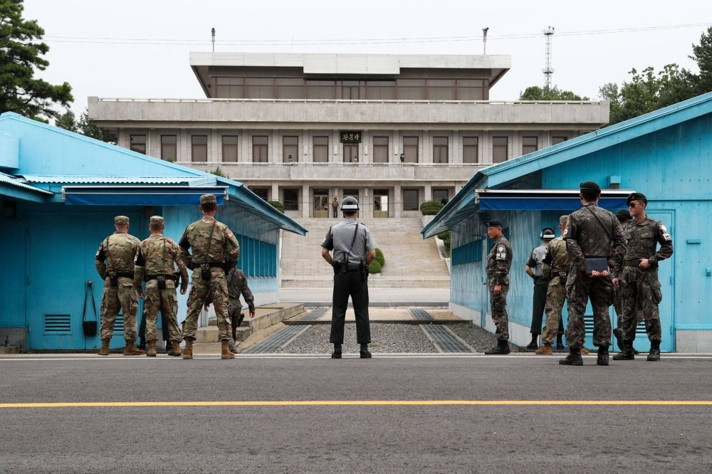 South Korean and U.S. soldiers stand guard next to the United Nations Command Military Armistice Commission building on the South Korean side of the Demilitarized Zone at Panmunjom in July 2017.