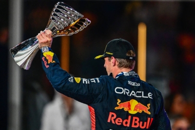 Max Verstappen of Red Bull Racing celebrates on the podium with the trophy after winning the Abu Dhabi Formula One Grand Prix at the Yas Marina Circuit on Sunday.