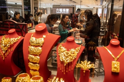Chinese tourists buy gold bars and gold accessories at LukFook, a jewelry store, in Hong Kong. 