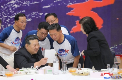 North Korean leader Kim Jong Un chats with senior officials during a banquet to celebrate the launch of a reconnaissance satellite, at the Mulan Pavilion in Pyongyang, in this image released Friday.  
