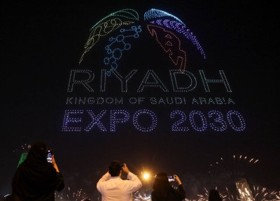 People watch fireworks and a light show as Saudi Arabia celebrates winning its bid to host the World Expo 2030, in Riyadh on Tuesday.