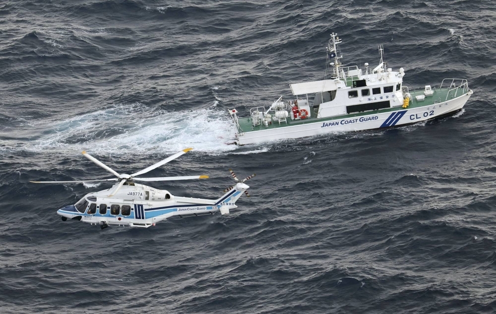 A Japan Coast Guard ship and helicopter search the area on Thursday where a U.S. military Osprey aircraft crashed off Yakushima in Kagoshima Prefecture a day earlier.