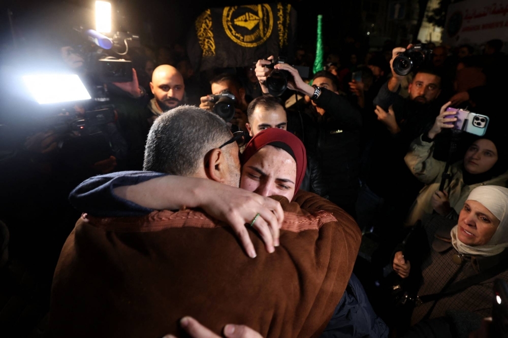 A newly released prisoner (right) hugs a relative during a welcome ceremony following the release of Palestinian prisoners from Israeli jails in exchange for Israeli hostages held in Gaza by Hamas since the Oct. 7 attacks, in Ramallah in the occupied West Bank on Thursday.