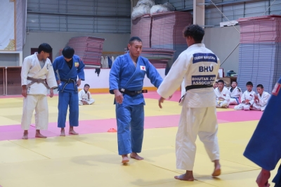 Yuki Fukui (center) squares up against a student during a training session at a judo dojo in Thimphu, Bhutan.