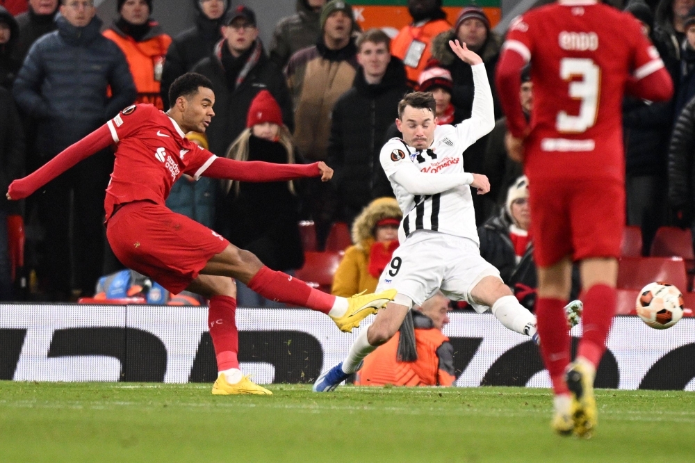 Liverpool striker Cody Gakpo (left) shoots to score his team's fourth goal during the UEFA Europa League group E football match between Liverpool and Linzer ASK at Anfield in Liverpool, England, on Thursday. Liverpool won the game 4-0.