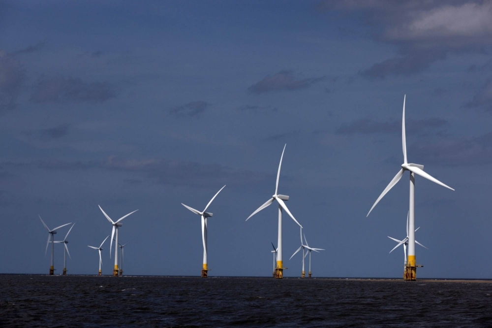 Offshore wind turbines at the Scroby Sands Wind Farm, operated by E.ON SE, near Great Yarmouth, United Kingdom.  Foreign wind power companies say Japan's development process for offshore wind power takes much longer than in other countries, leading to more uncertainty and risks.