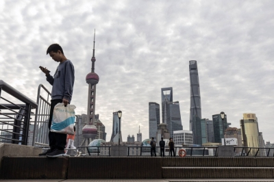 Pedestrians along the Bund in Shanghai on Oct. 29. The Chinese government is pushing a narrative that the city will play an important role in reinvigorating the nation’s economy.