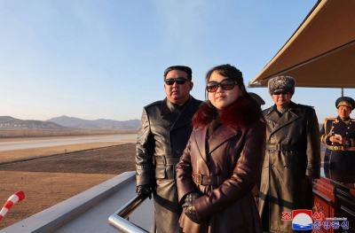 North Korean leader Kim Jong Un and his daughter observe an air festival during a visit with the 1st Air Force Division Flying Regiment of the Korean People's Army to commemorate Air Day, at an unknown location on Thursday.