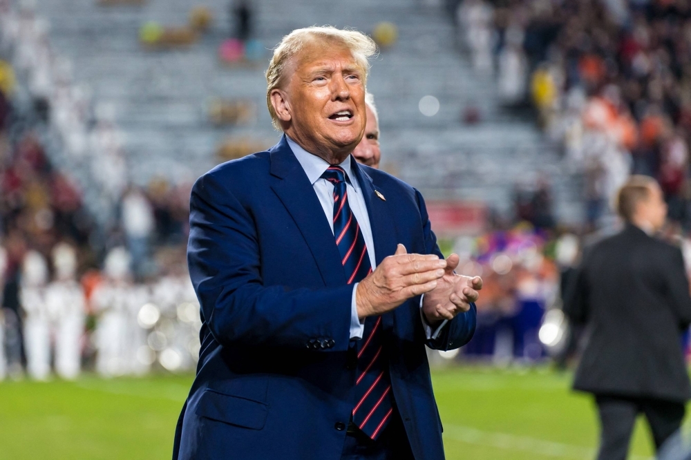 Former U.S. President Donald Trump acknowledges the crowd during halftime of a game between the South Carolina Gamecocks and Clemson Tigers at Williams-Brice Stadium in Columbia, South Carolina, on Nov. 25.