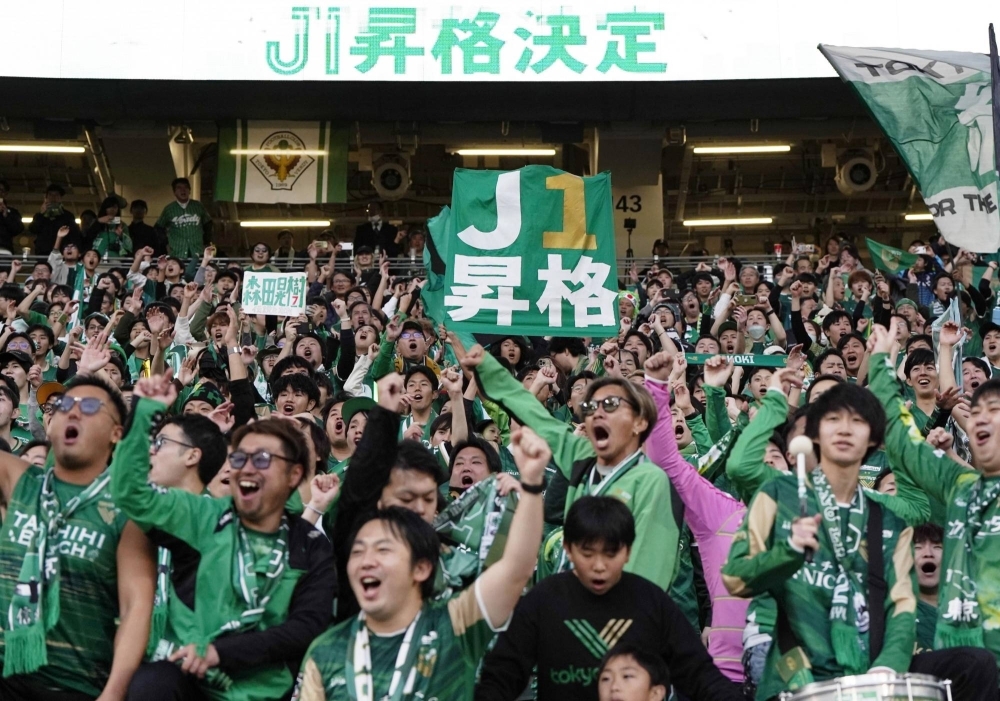 Tokyo Verdy fans celebrate after the club secured promotion to the top flight of the J. League on Saturday at National Stadium in Tokyo. 