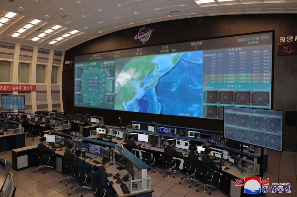 Digitally blurred screens at the Pyongyang General Control Center of the Korean National Aerospace Technology Directorate are seen on Nov. 22, a day after the launch of a rocket carrying a military reconnaissance satellite, in Pyongyang. 