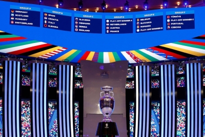 The Euro trophy in front of the drawn groups for the 2024 edition of the tournament, in Hamburg, Germany, on Saturday