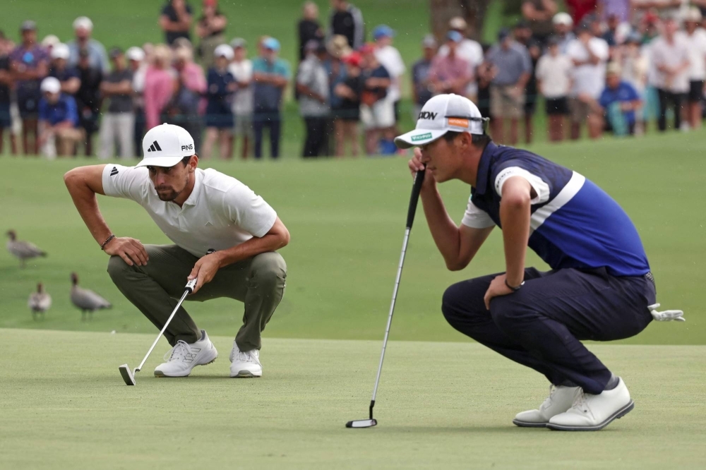Chile's Joaquin Niemann (left) and Japan's Rikuya Hoshino line up their putts during a playoff on the final day of the Australian Open in Sydney on Sunday. 
