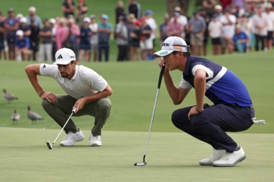 Chile's Joaquin Niemann (left) and Japan's Rikuya Hoshino line up their putts during a playoff on the final day of the Australian Open in Sydney on Sunday. 