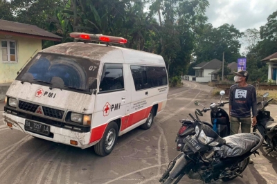 An emergency vehicle drives through volcanic ash from the eruption of Mount Marapi near Sumatra Island's village of Nagari Lasi on Sunday. 

 