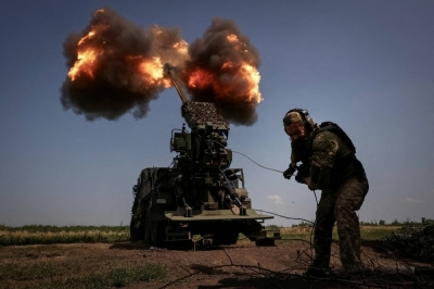 A Ukrainian serviceman fires a self-propelled howitzer toward Russian troops. 