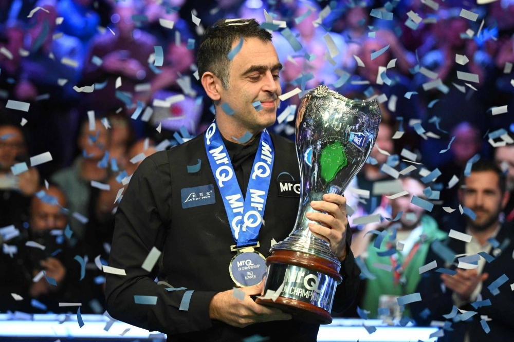 Ronnie O'Sullivan poses with the trophy after winning the UK Championship in York, England, on Sunday.