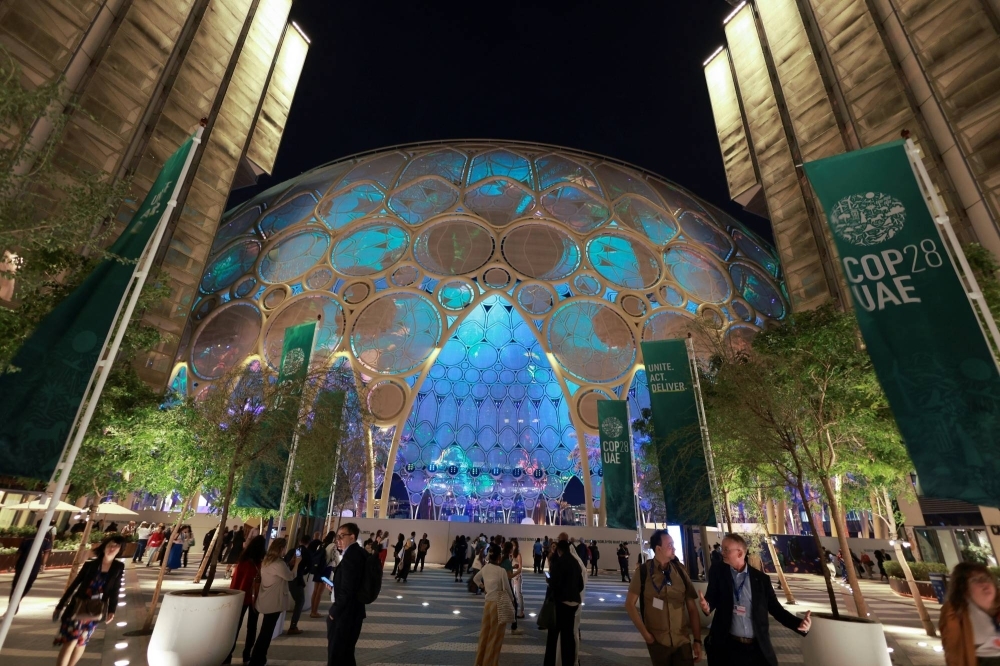 People walk through Dubai's Expo City during COP28 on Monday.