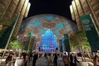 People walk through Dubai's Expo City during COP28 on Monday. | REUTERS
