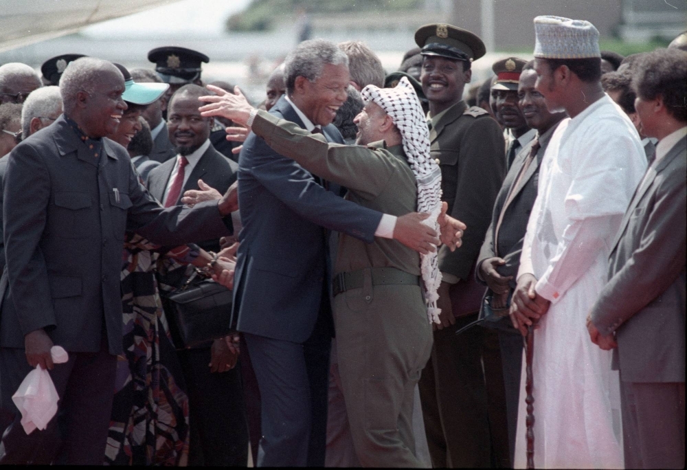 Nelson Mandela (left) is embraced by Palestine Liberation Organisation leader Yasser Arafat as he arrives at Lusaka airport on Feb. 27, 1990.